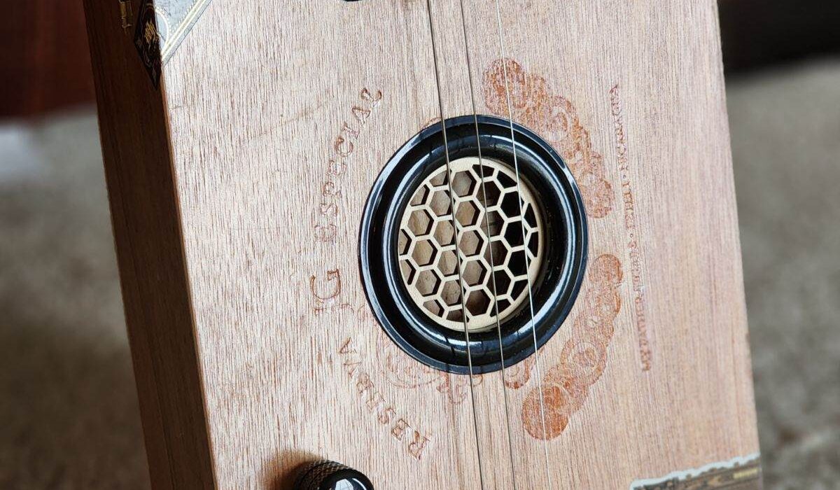 wooden cigar box guitar with honeycomb